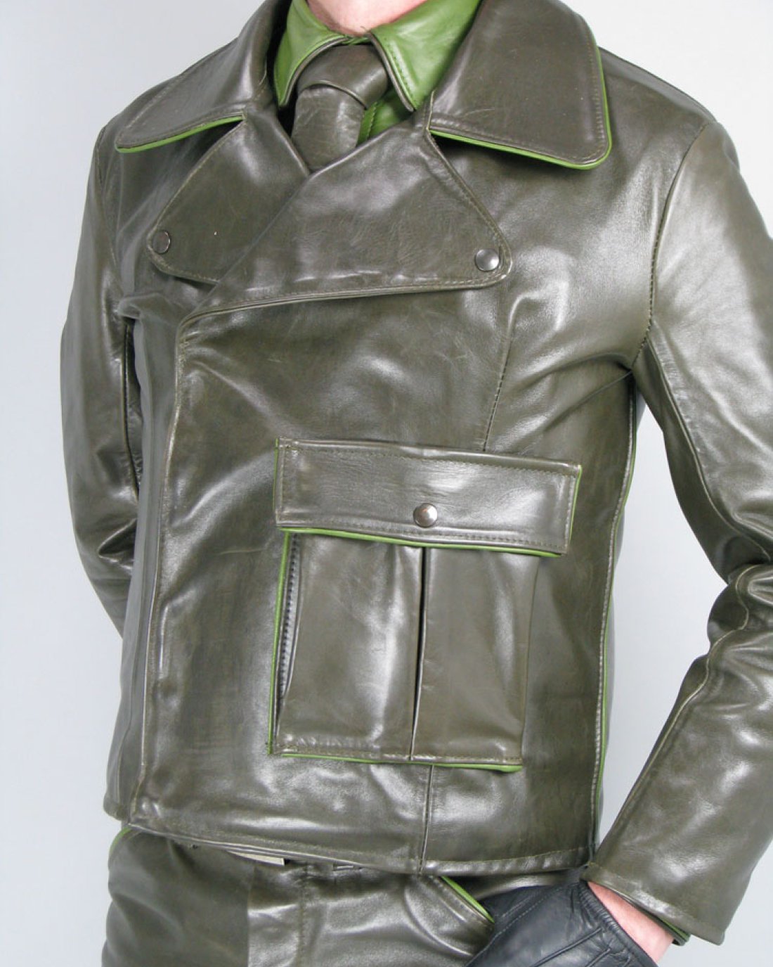 Tailored olive-green leather jacket with light green piping and a lapel collar