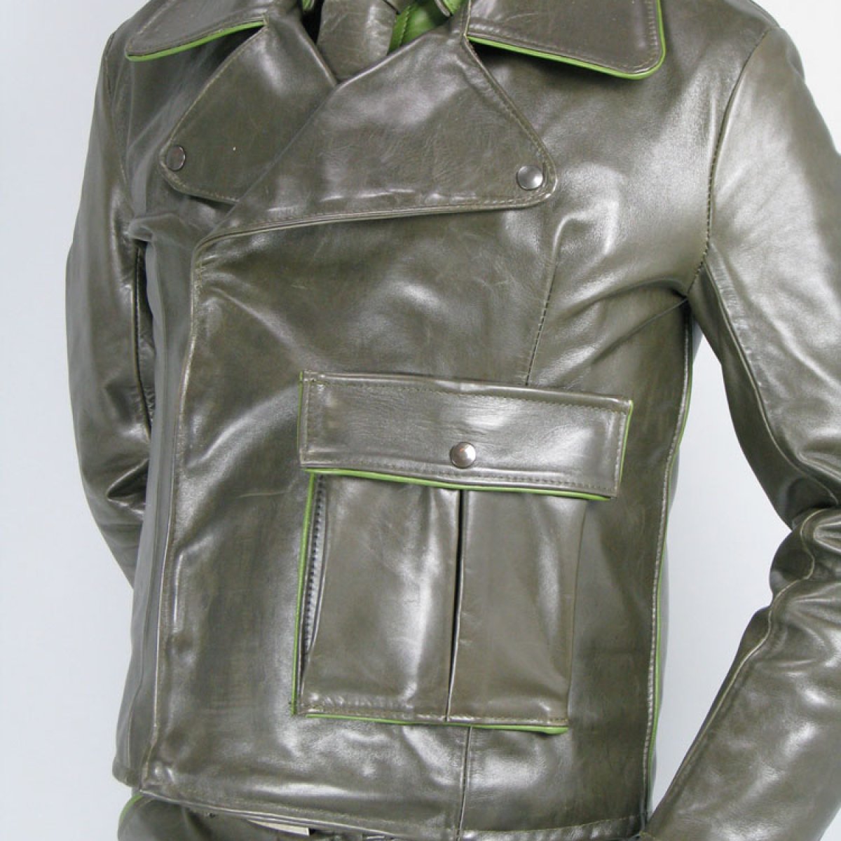 Tailored olive-green leather jacket with light green piping and a lapel collar
