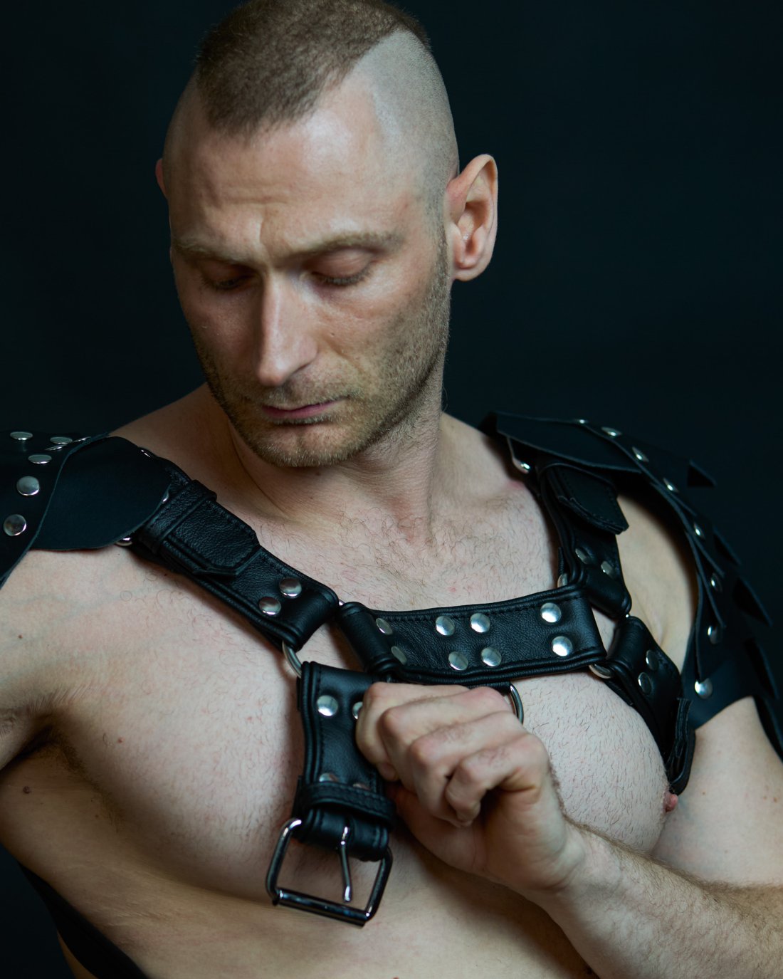 Black leather harness with a D-ring