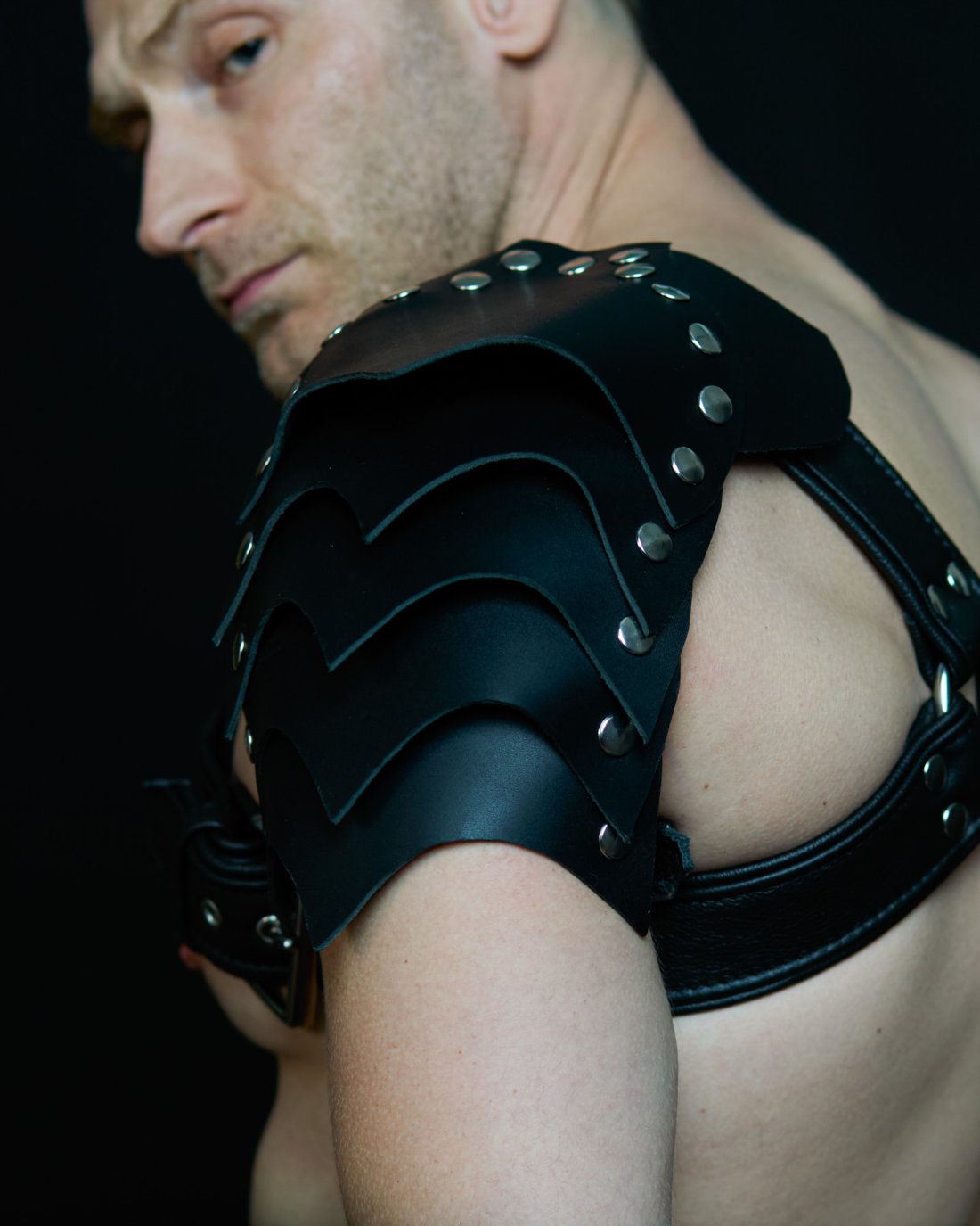 Black leather harness with black shoulder pads and silver studs